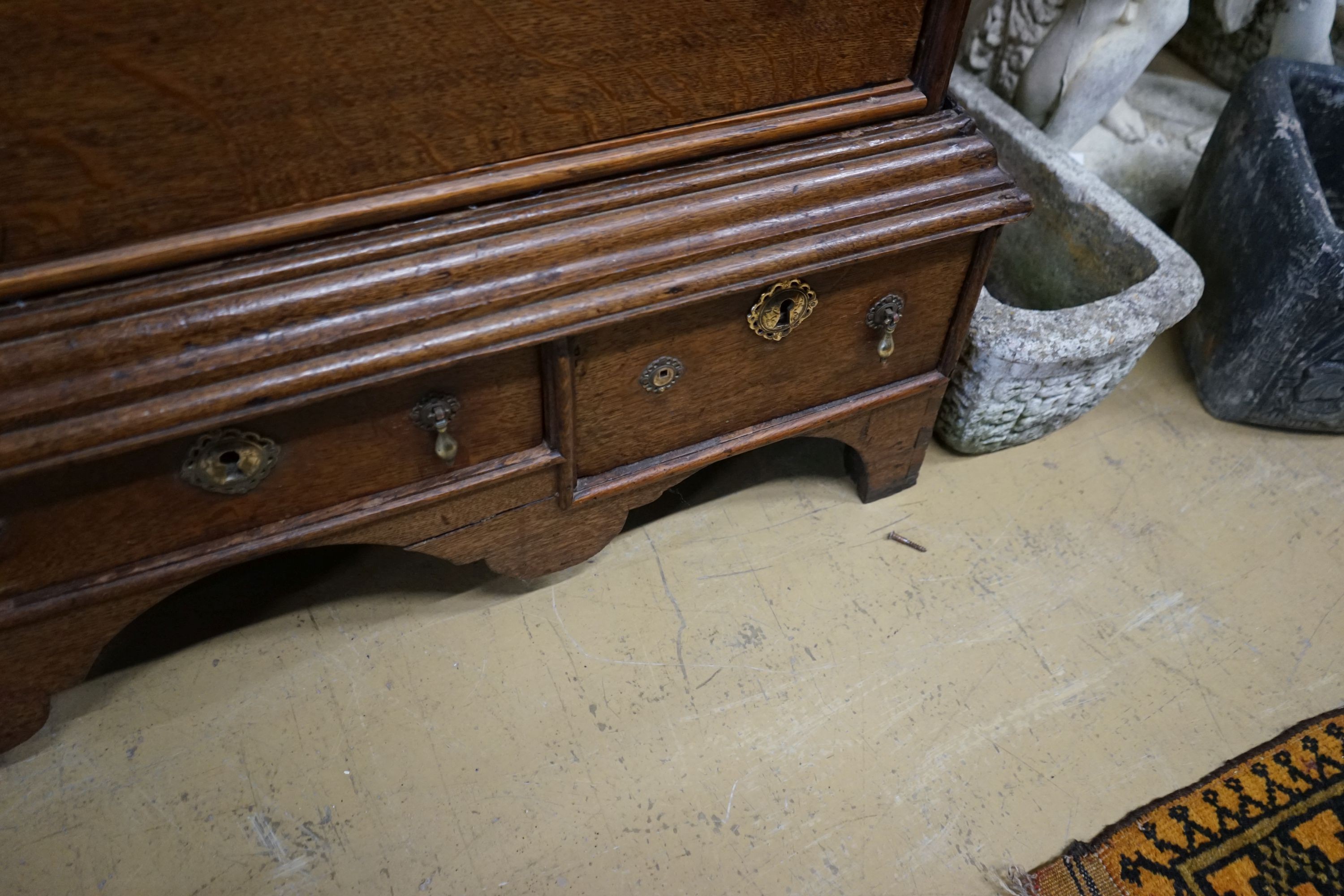 An 18th century oak chest on stand, width 104cm, depth 56cm, height 133cm